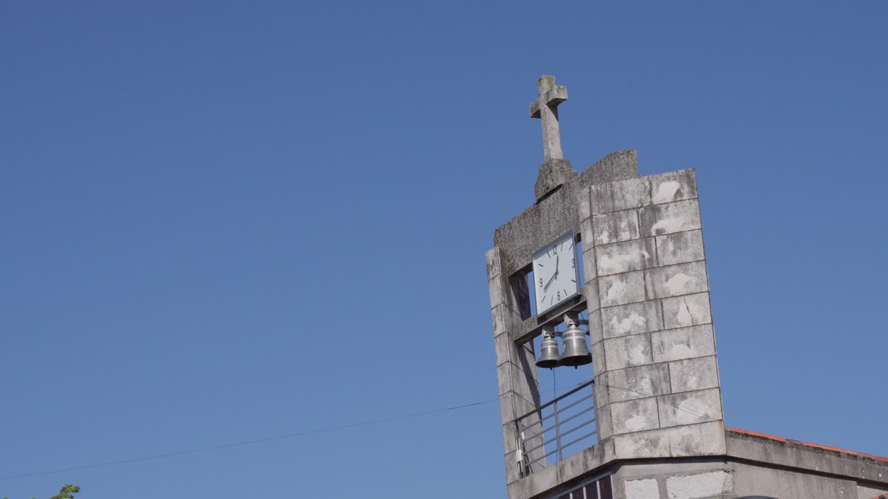 Belltower With Bell Hanging Analog Clock And Stone Cross Blue Clear Sky