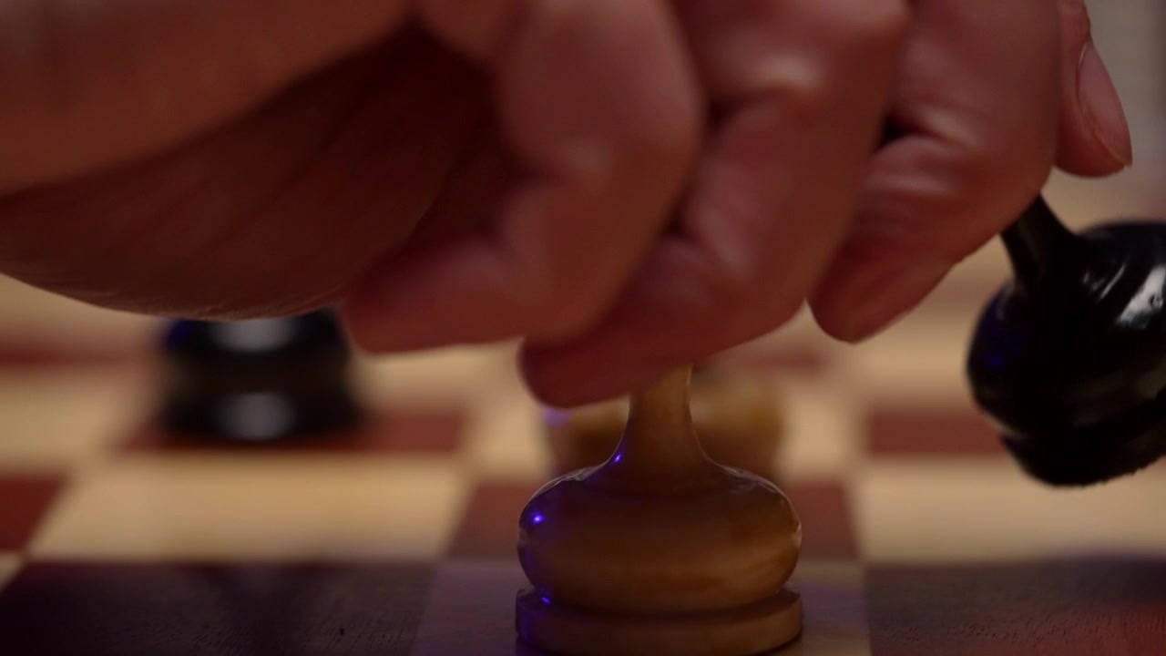 Hand Replaces White Chess Pawn with Black Pawn on Board