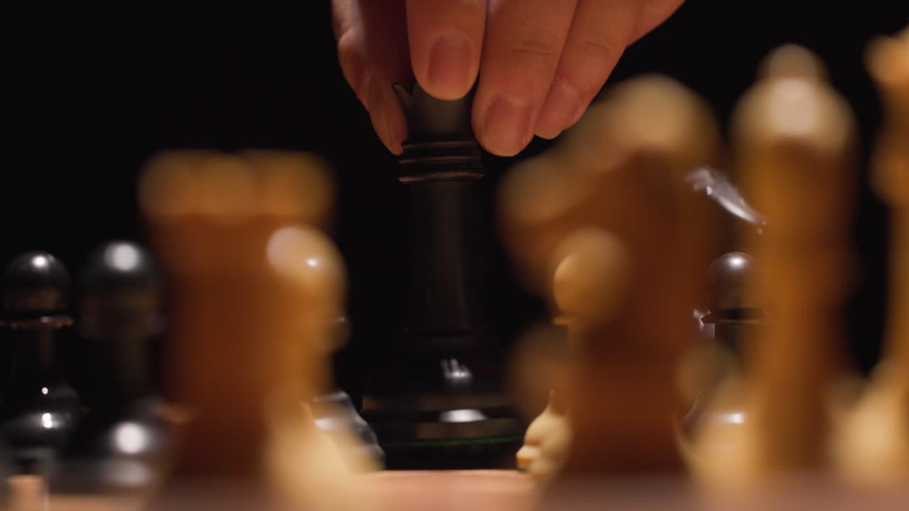 Player moves queen onto chess spot to take white chess piece