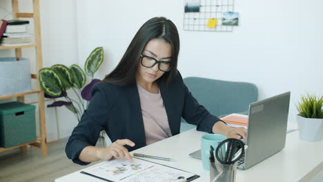businesswoman working on laptop and reports in the office