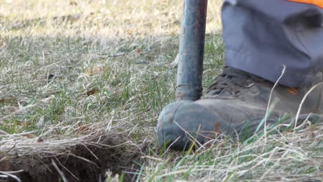 A-man-digs-a-pit-with-a-shovel,-close-up