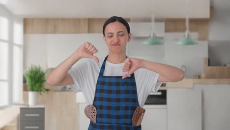 upset indian housewife showing thumbs down