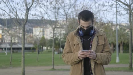 Masked-Man-Using-Phone