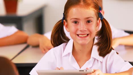 Schoolgirl-using-digital-tablet-in-classroom