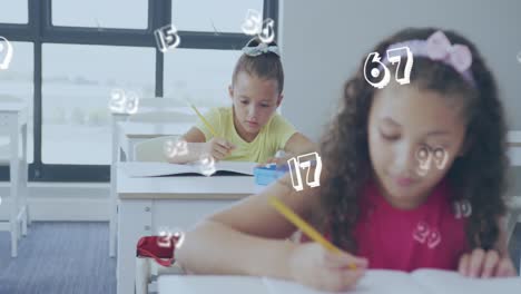 Animation-of-numbers-over-happy-diverse-schoolgirls-working-at-desks-in-class