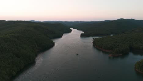 aerial view of dreamy tropic forest landscape with small boat on river