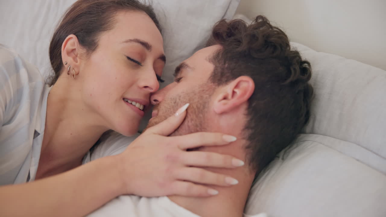 Love, bedroom and face of couple kiss