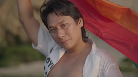man holding rainbow flag