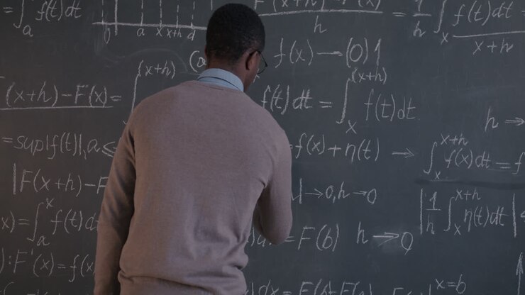 Teacher Explaining Mathematics on Chalkboard