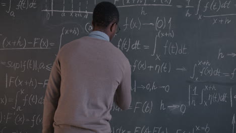 teacher explaining mathematics on chalkboard