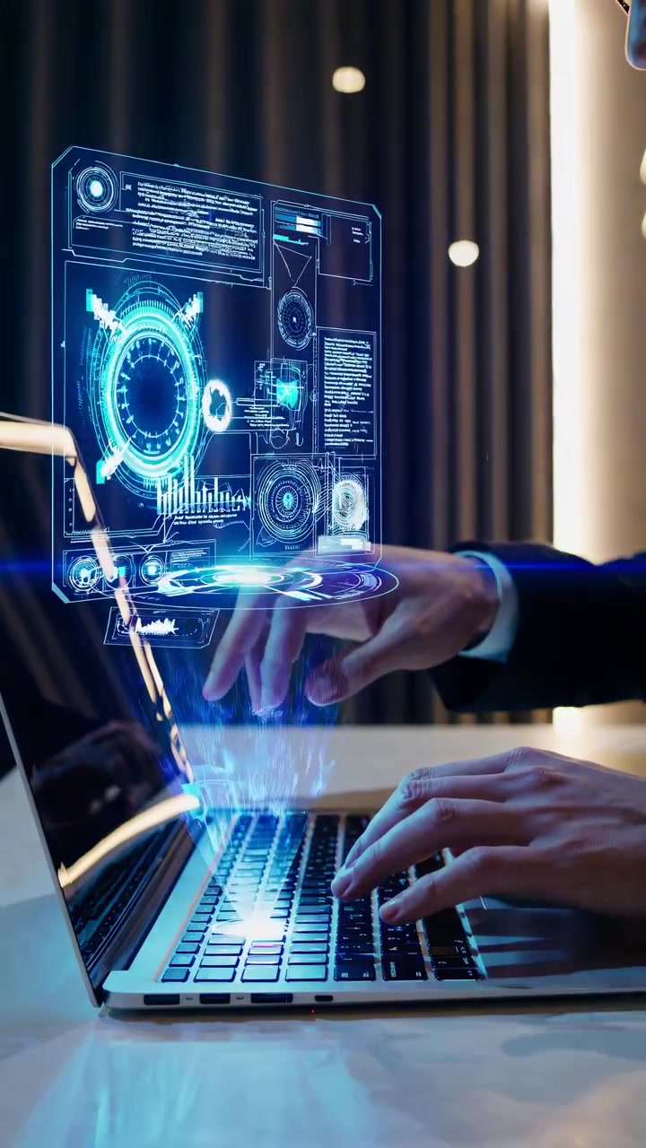Person Typing on Laptop Interacting with Futuristic Holographic Display