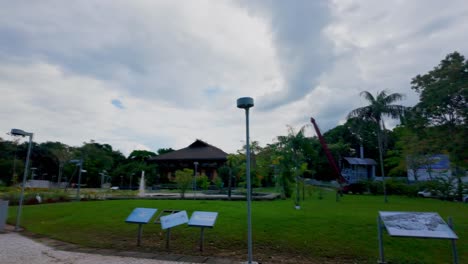 A park with a tower, pavilion, and tropical plants