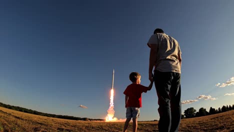 father and son watching a rocket launch