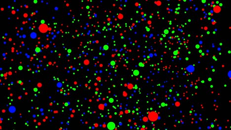 puntos rojos, verdes y azules se mueven sobre un fondo negro