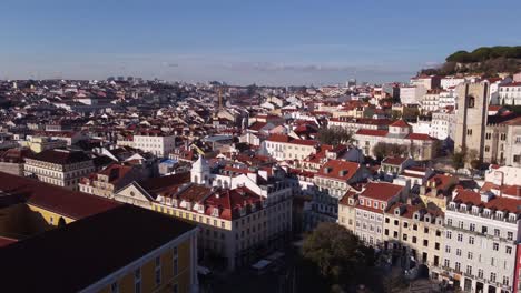 drone descending over lisbon portugal on a bright sunny winter day over alfama district in europe