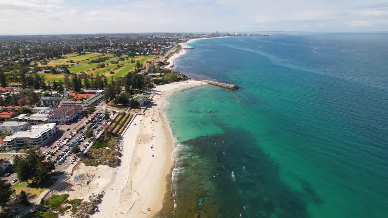 Aerial view of a beach, coastline, and city