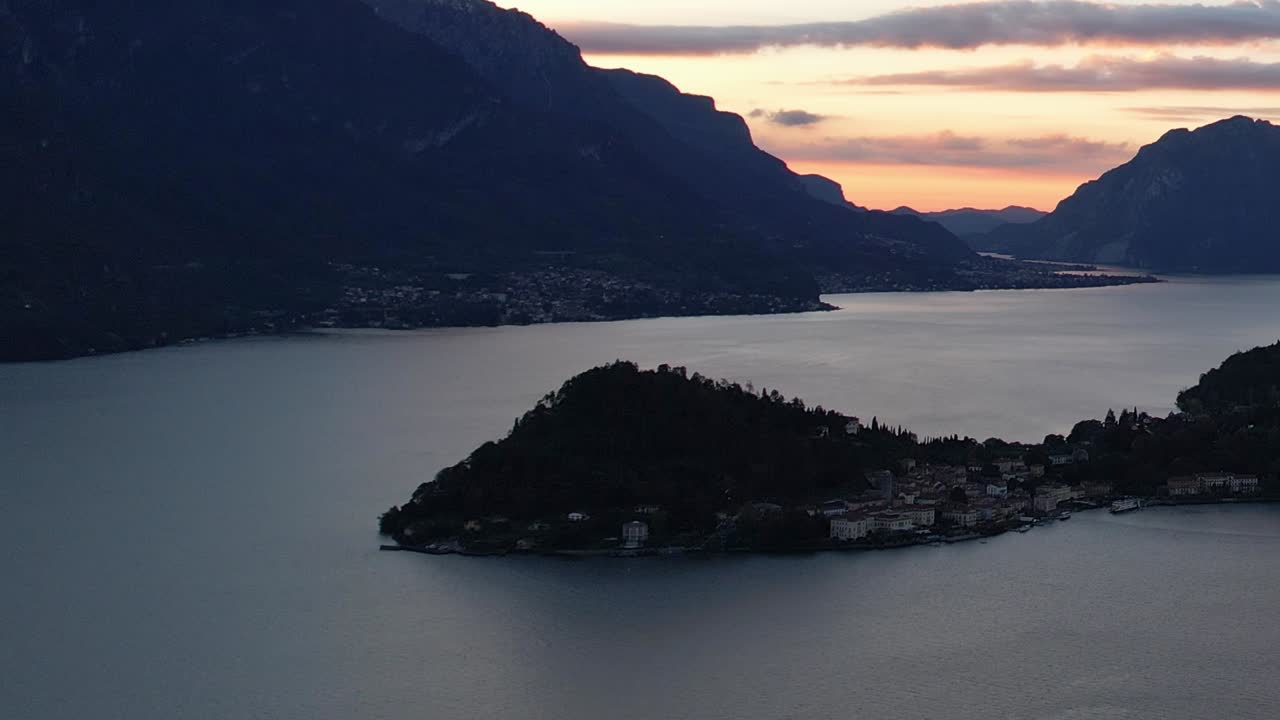 Captivating aerial view of a serene lake in the Italian Alps at sunset