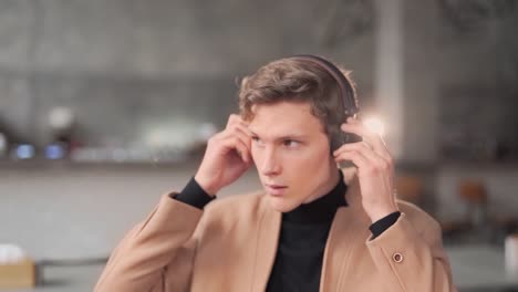 large-portrait-of-a-nice-guy-listening-to-music-in-headphones