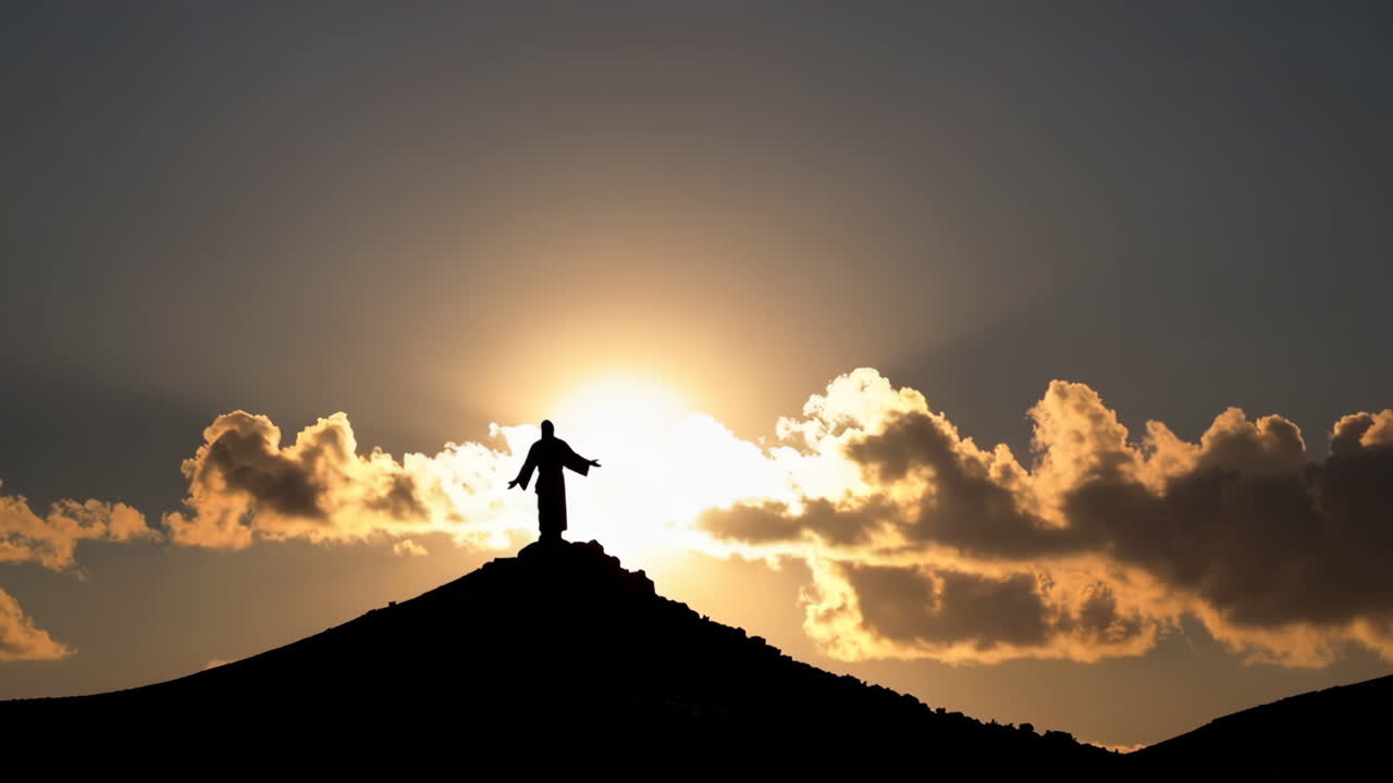 Jesus Statue on Mountain Sunset