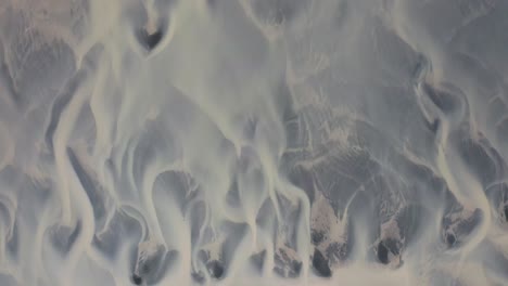 aerial birds eye shot of braided channel system on iceland during sunny day, europe