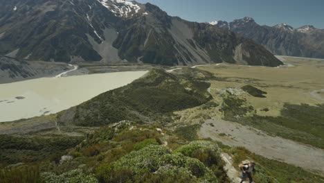Woman-going-up-Sealy-Tarns-mountain-trail-on-perfect-sunny-day,-Mount-Cook-National-Park