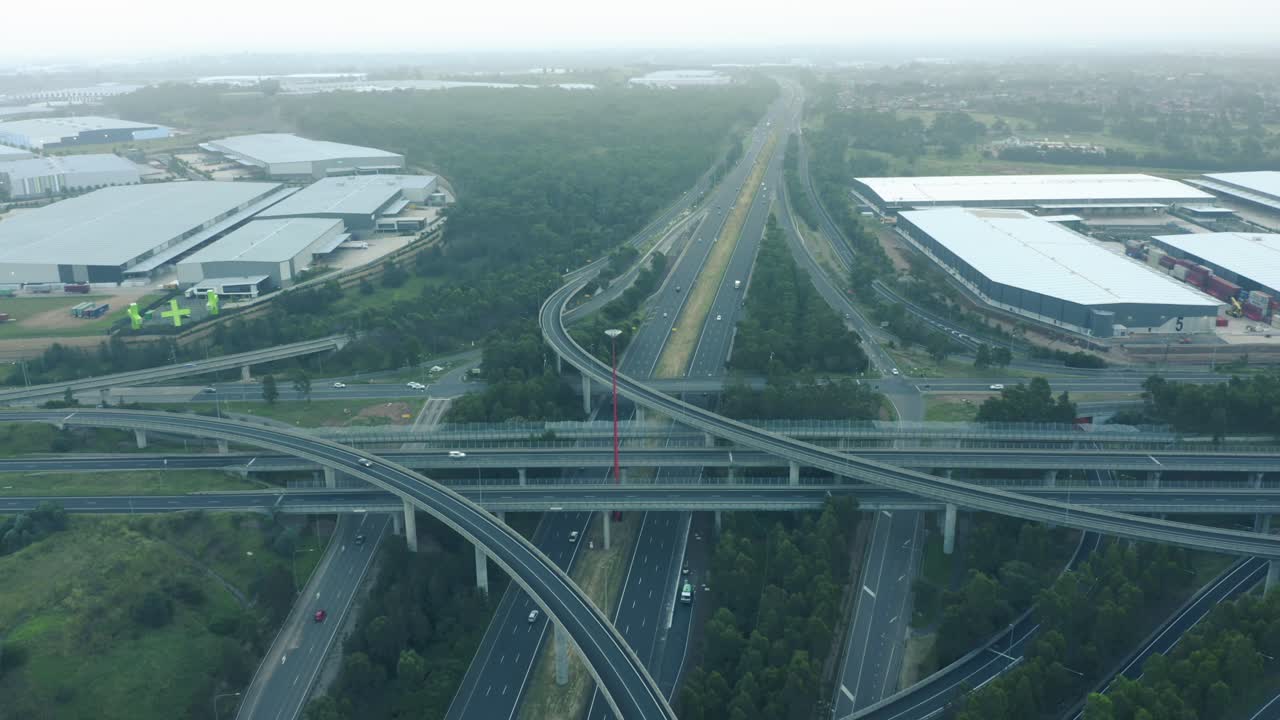 Motorways M4 and M7 light horse interchange in Sydney western suburbs &ndash; aerial panning over multi-lane highways with traffic