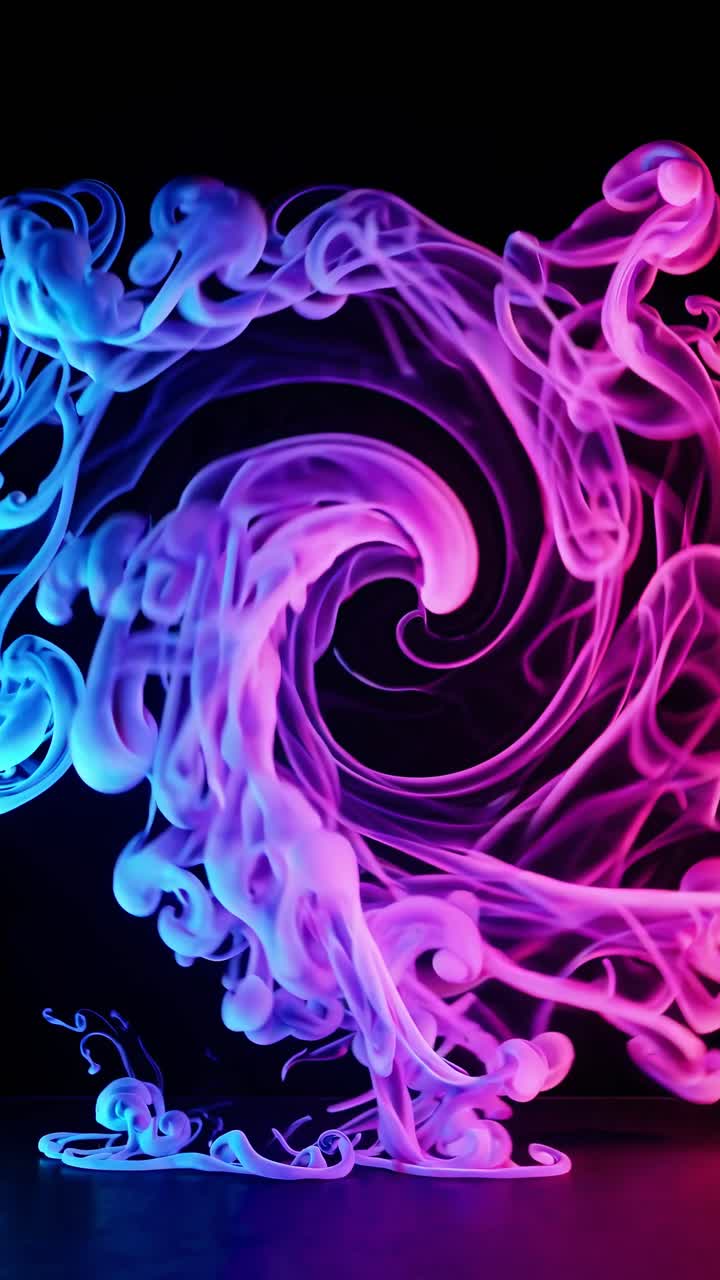 Vibrant swirling pink and blue smoke in a dynamic, close-up video shot, creating a mesmerizing