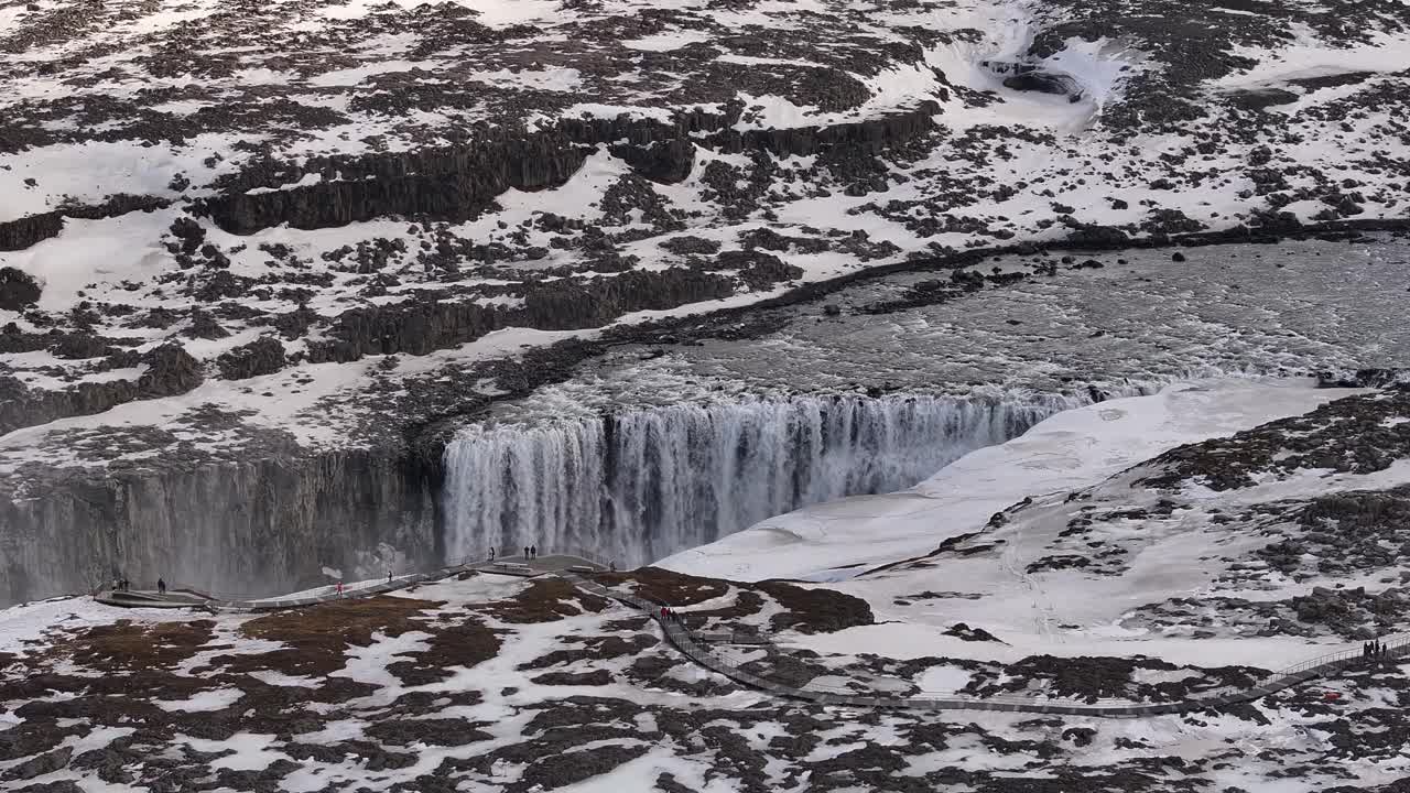 Dettifoss waterfall surrounded by snow in Iceland breathtaking aerial view, winter beauty meets raw nature power.