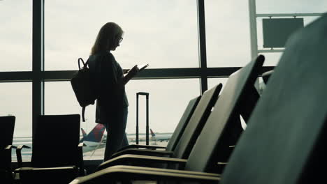 Woman-in-Airport-Uses-a-Tablet