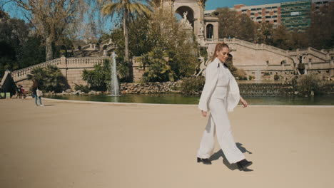 stylish young woman walking in the park outdoors.