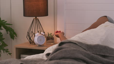 man waking up to alarm clock