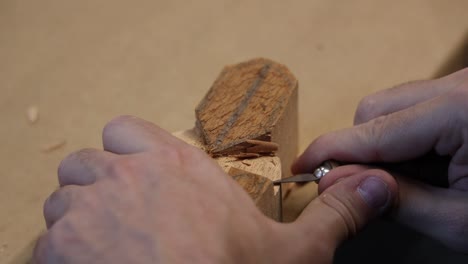 artisan sculpting, a wood religious figure