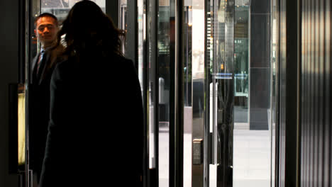 Rear-view-of-businesswoman-leaving-hotel-with-luggage-4k