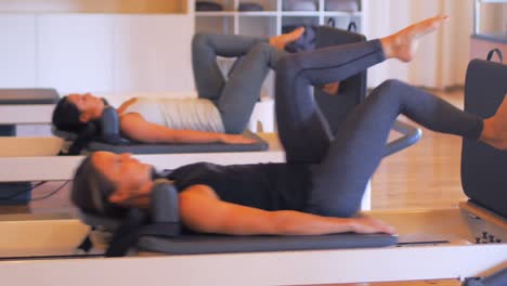women exercising on gym equipment