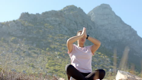 meditating while practicing yoga, woman enjoying nature during mountain hike