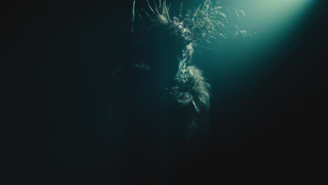 a creepy witch rises her head during the night storm
