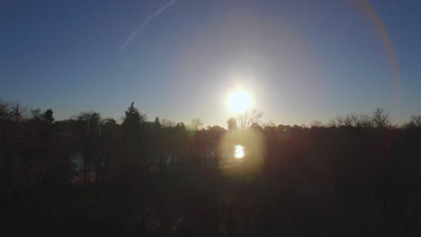 flying over buen retiro park in madrid spain winter view with shining sun