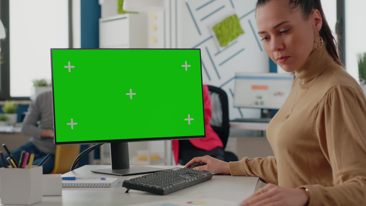 Company worker using isolated green screen on monitor