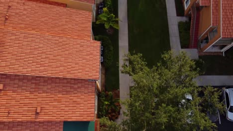 Woman walk on sidewalk outside row houses. Real estate concept in Naples, Florida. Aerial view