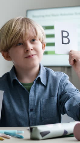 Boy Holding Letter B during a School Activity