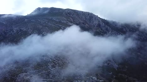 aerial shot through the clouds above puig gros summit, mallorca, spain