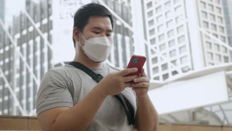 Tourist-with-Mobile-in-Hand-stand-in-the-city-center-street-uses-mobilephone