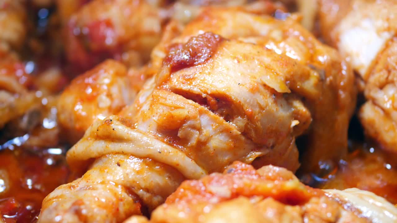 Close-up of Cooked Chicken in a Red Sauce