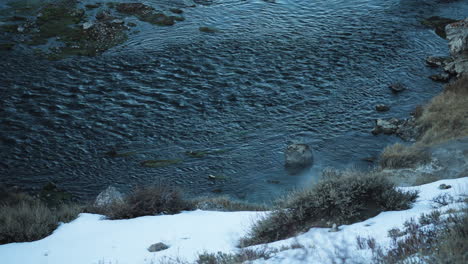 Hillside-with-Snow-and-Steam-from-Hot-Springs,-Hot-Creek-Geological-Site,-California,-High-Angle