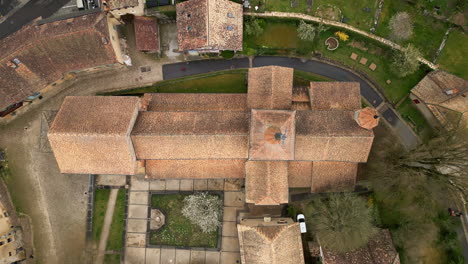 top down drone shot of romainmotier priory, former cluniac priory, during the day in canton of vaud, switzerland