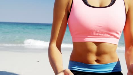 Fit-woman-performing-yoga-at-beach