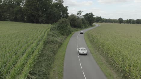 vintage cars racing on pau-arnos countryside circuit