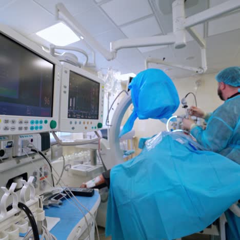 operation in surgical room. medical monitors show patient's condition during surgery. doctors in medical uniform operate patient in hospital.