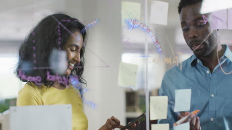 Animation-of-spinning-globe-against-diverse-man-and-woman-discussing-over-memo-notes-at-office