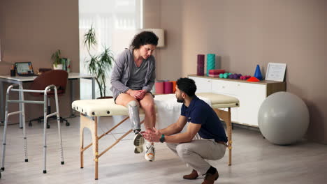 a physical therapist working with a patient who has a prosthetic leg.